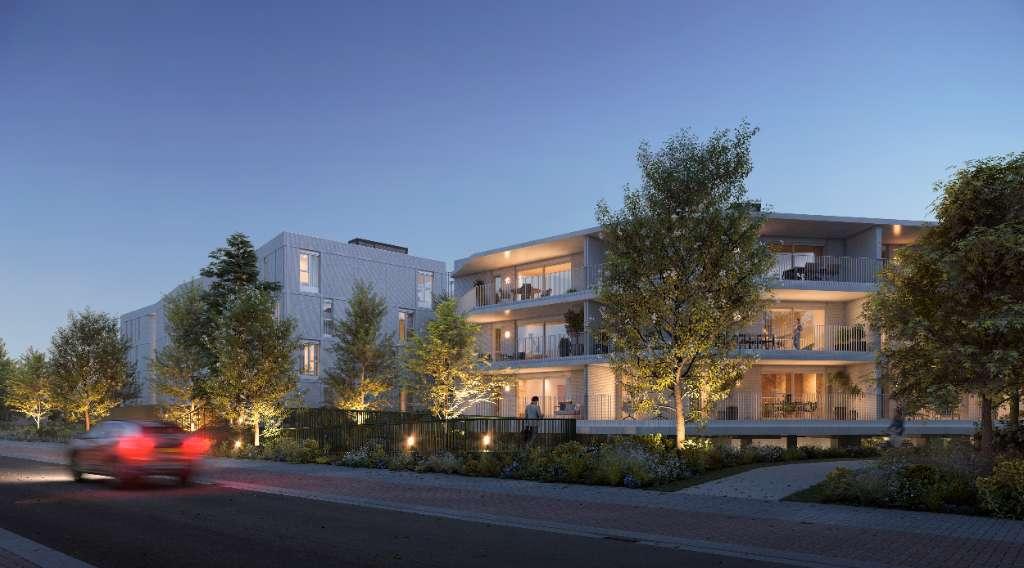 Zijgevel en groene omgeving van Kuringen Park nieuwbouwproject in Kuringen, Hasselt